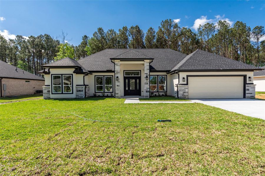Front exterior of a new home in , Dayton, TX, highlighting curb appeal (Image 24).