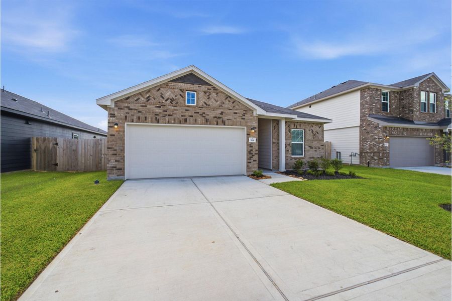 Front exterior of a new home in Trails at Woodhaven Lakes, La Marque, TX, highlighting curb appeal (Image 2). Front exterior of a new home in Trails at Woodhaven Lakes, La Marque, TX, highlighting curb appeal (Image 2).