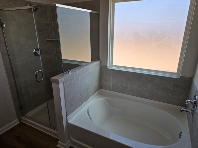 The Shetland III- Primary Bathroom with garden tub and separate shower. included). Home under construction, photo used for illustrative purposes only, colors and options will vary. The Shetland III- Primary Bathroom with garden tub and separate shower. included). Home under construction, photo used for illustrative purposes only, colors and options will vary.