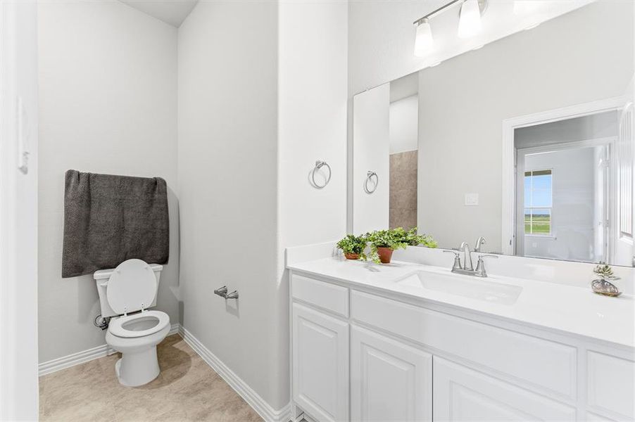 Bathroom with vanity and light tile patterned floors
