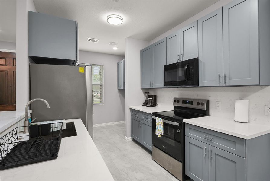 Cook with confidence.Featuring quartz countertops, modern cabinetry, and plenty of prep space for your favorite recipes. Cook with confidence.Featuring quartz countertops, modern cabinetry, and plenty of prep space for your favorite recipes.