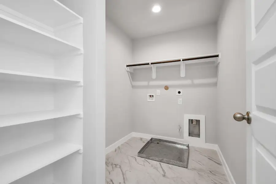 Utility room with both electric and dryer connections. Sample photo of completed home with similar floor plan. Actual colors and selections may vary.