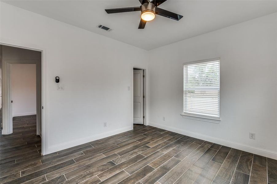 Unfurnished room with wood tiled floors and ceiling fan Unfurnished room with wood tiled floors and ceiling fan