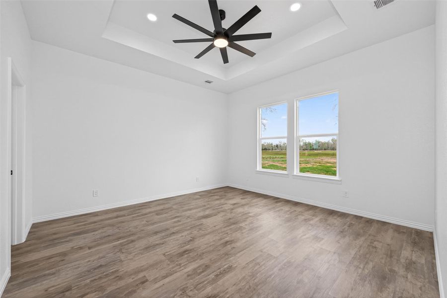 Expansive primary suite with high ceilings and plenty of natural light.