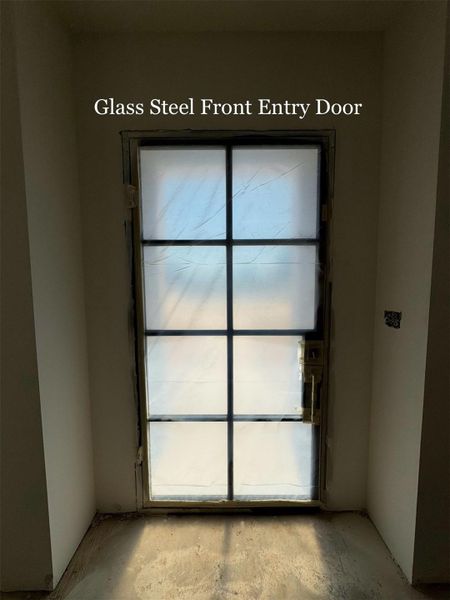 Modern Glass and Steel Front Entry Door creates a bold first impression while filling the foyer with light.
