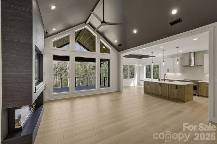 The floor plan is very open. The views out the large glass "wall" of windows are extremely captivating. This is the family room with its vaulted ceiling. There are lots of contemporary technology used in this home including Satco Recessed "Dimmable" LED can lighting which offers a modern, energy-efficient upgrade over traditional lighting. Also, there are Ecobee Smart Wifi thermostats that combine comfort, convenience, and smart home integration. The floor plan is very open. The views out the large glass "wall" of windows are extremely captivating. This is the family room with its vaulted ceiling. There are lots of contemporary technology used in this home including Satco Recessed "Dimmable" LED can lighting which offers a modern, energy-efficient upgrade over traditional lighting. Also, there are Ecobee Smart Wifi thermostats that combine comfort, convenience, and smart home integration.