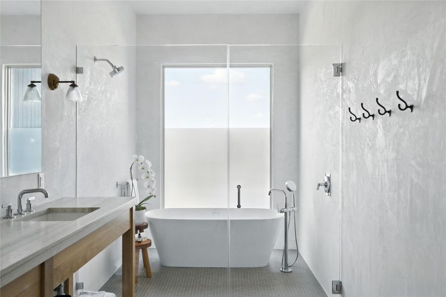 Full bathroom with a soaking tub and vanity