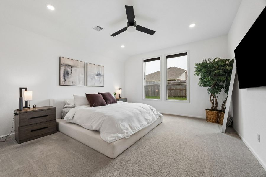The primary bedroom is oversized with plenty of natural light and storage. The upgraded fan and automatic window shades make for a calm and comfortable retreat. The primary bedroom is oversized with plenty of natural light and storage. The upgraded fan and automatic window shades make for a calm and comfortable retreat.