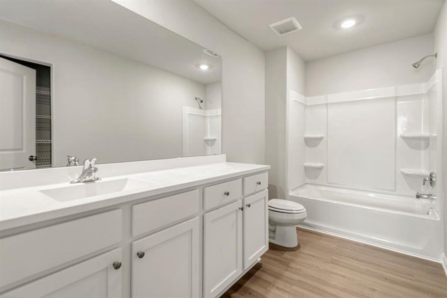 The secondary bathroom, located on the second floor of the home.