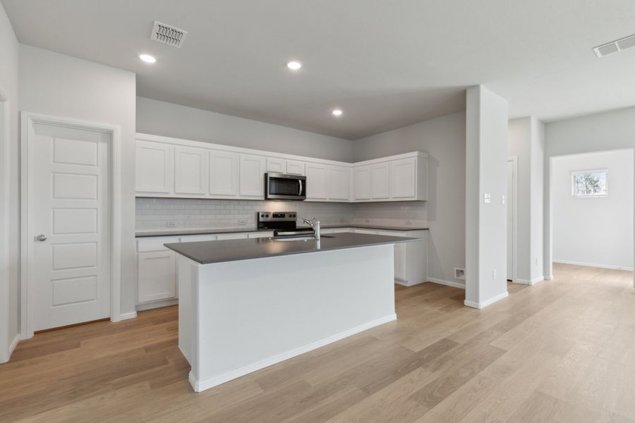 Kitchen in the Hayden home plan by Trophy Signature Homes – REPRESENTATIVE PHOTO