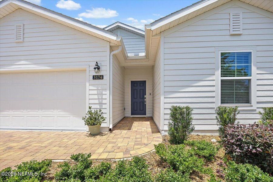 Exterior details and patio area of a home in Edenbrooke at Hyland Trail | 55+, Green Cove Springs (Image 3).