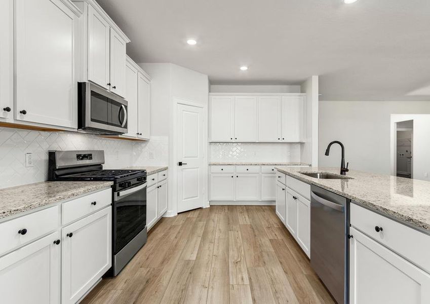 A full suite of stainless steel appliances fill the kitchen