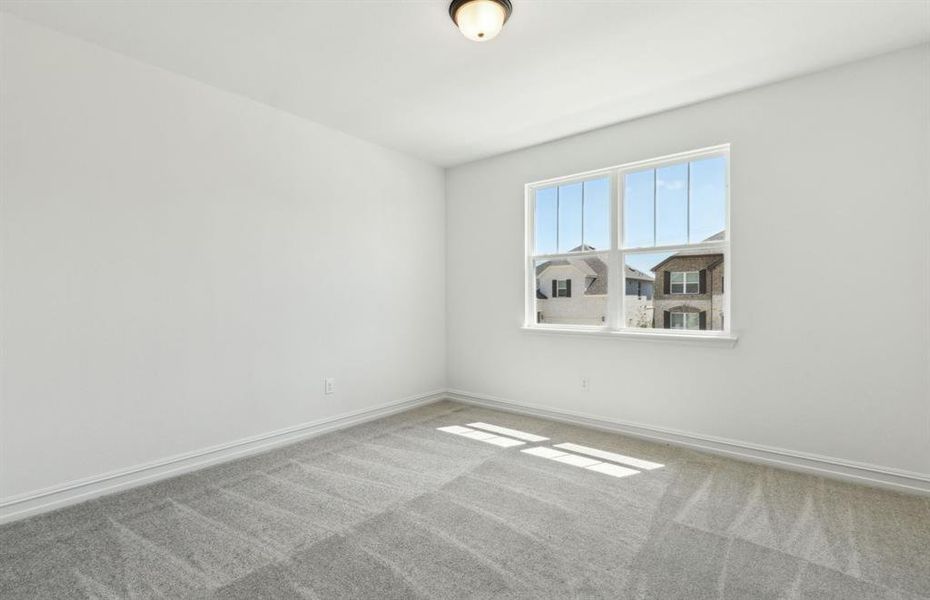 Roomy secondary bedroom with extensive closet storage *Real home pictured