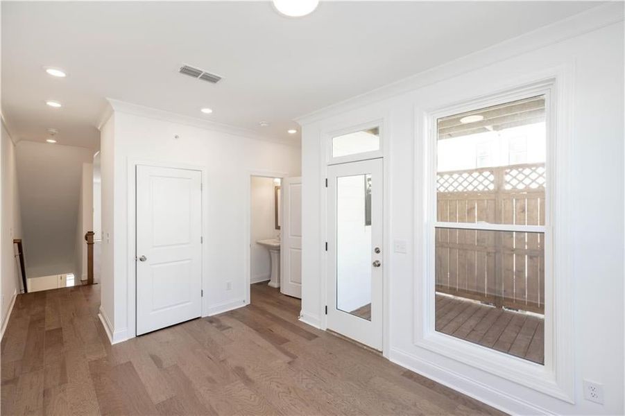 Just off the sunroom is a powder room and laundry room plus access to the covered deck.