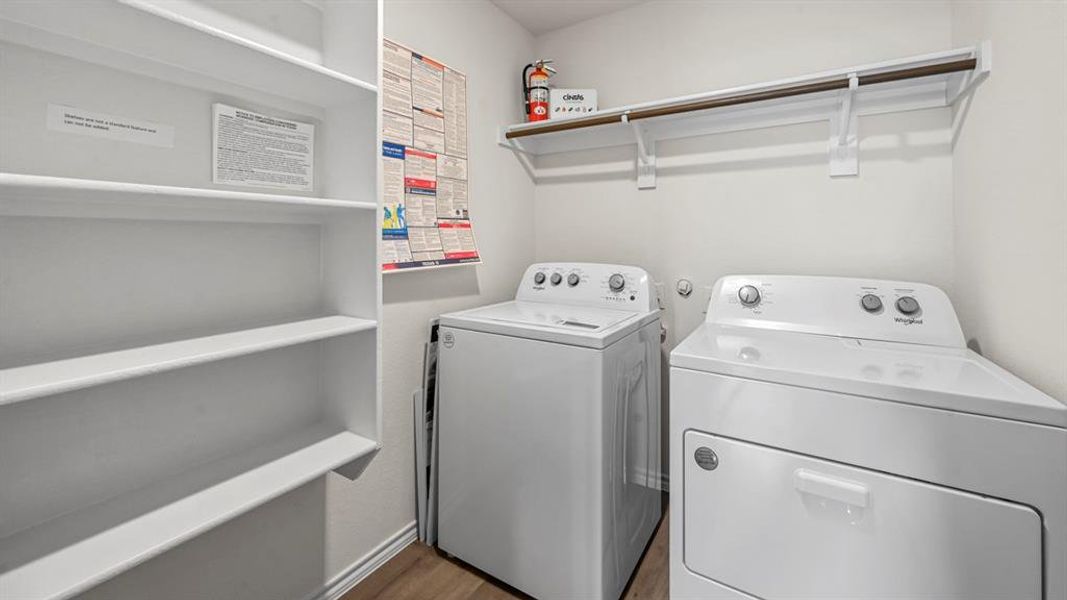Laundry room with washing machine and clothes dryer and dark wood-type flooring
