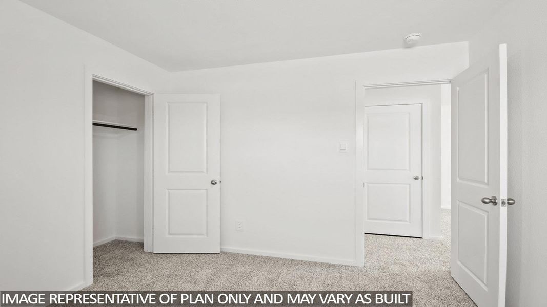 Unfurnished bedroom featuring light carpet and a closet Unfurnished bedroom featuring light carpet and a closet