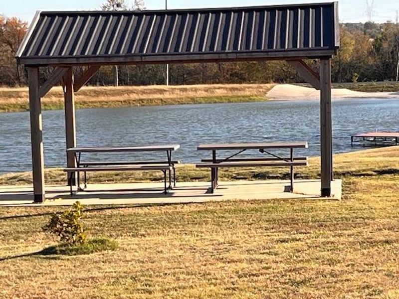 Surrounding community with a water view and a yard