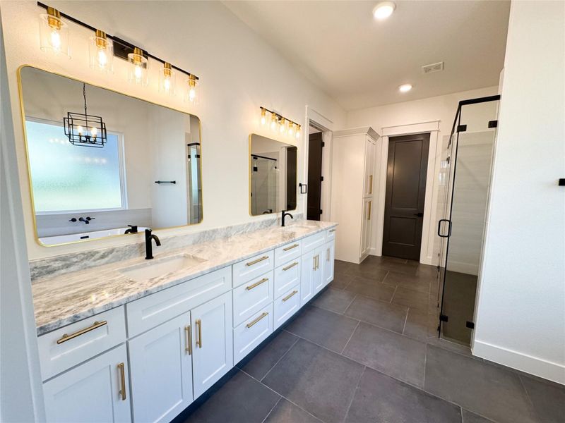 Primary Bedroom offers Spacious Double Sink Vanity, Large Linen, and many Designer Details