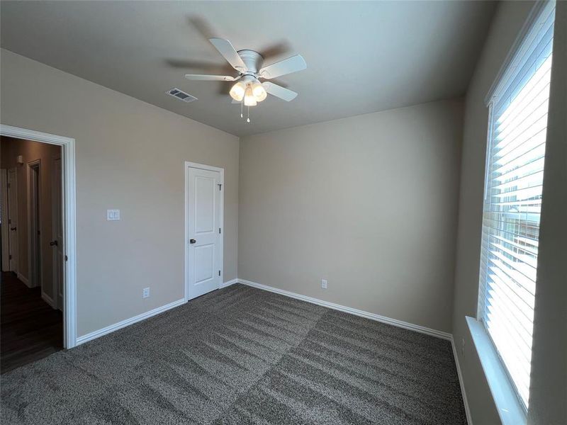 Bedroom 2, Carpeted empty room featuring ceiling fan