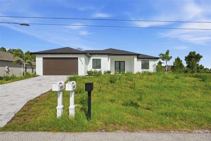 Front exterior of a new home in , Port Charlotte, FL, highlighting curb appeal (Image 1). Front exterior of a new home in , Port Charlotte, FL, highlighting curb appeal (Image 1).