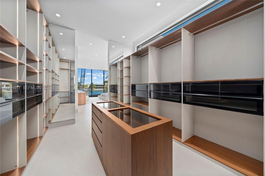 Built-in wood-finish cabinetry, recessed lighting, integrated drawer systems, full-length mirror, and large picture windows