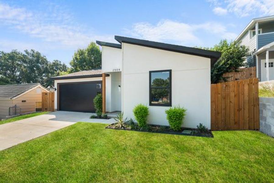 Contemporary house with concrete driveway, stucco siding, and a garage Contemporary house with concrete driveway, stucco siding, and a garage