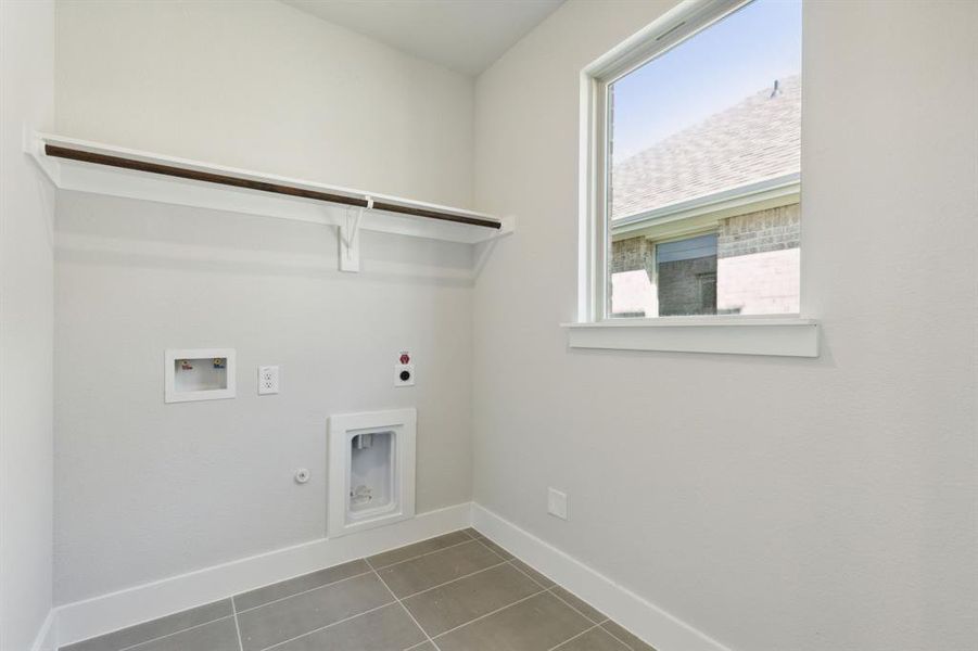 Carpeted empty room featuring ceiling fan, plenty of natural light, and lofted ceiling