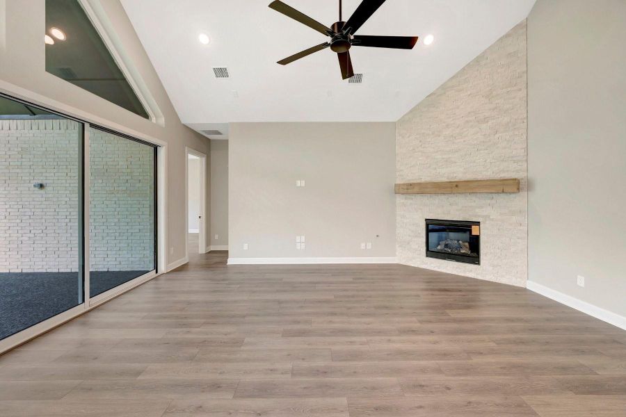 Another view of this spacious Living area with high ceilings and wired for sound.  Low maintenance laminate floors compliment this space!