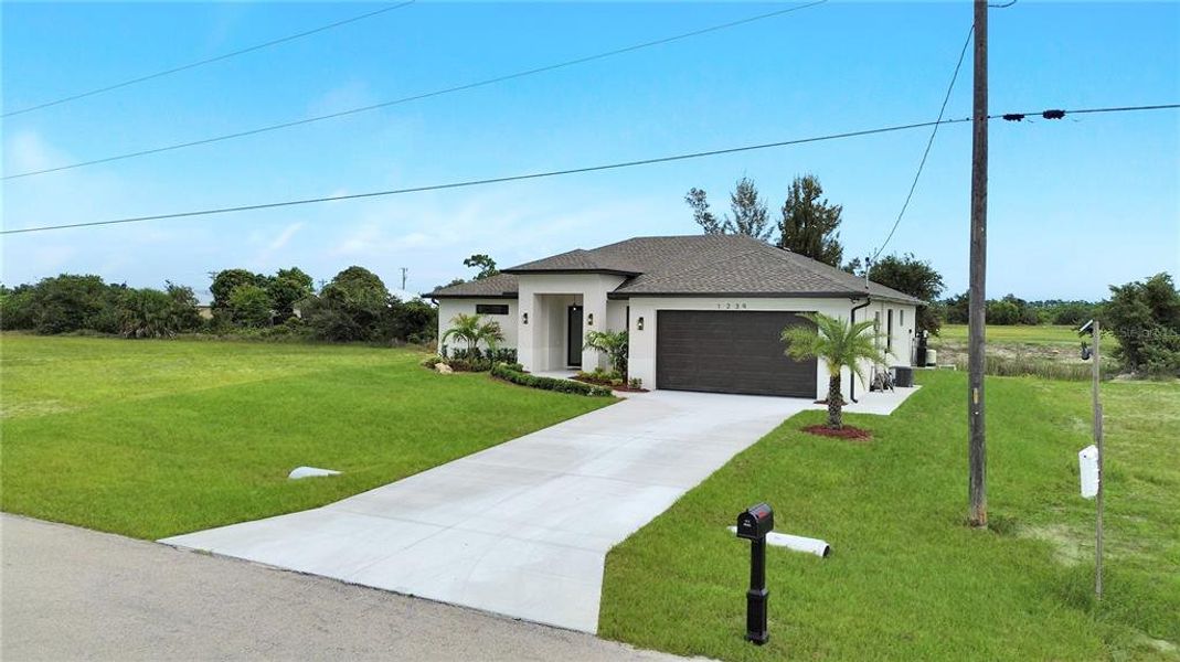 Front exterior of a new home in , Cape Coral, FL, highlighting curb appeal (Image 27).