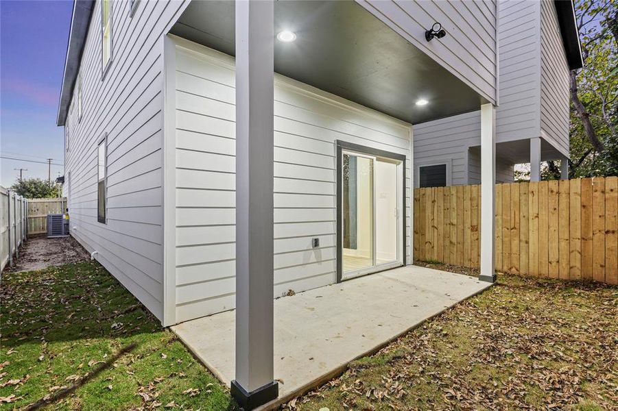 Property exterior at dusk featuring a patio and central air condition unit