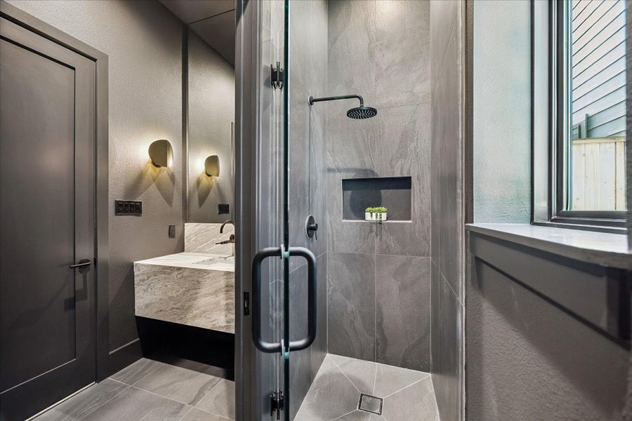 Walk-in shower with frameless glass doors. Walk-in shower with frameless glass doors.
