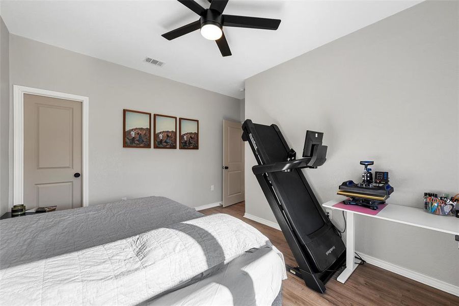 Bedroom with wood finished floors and a ceiling fan