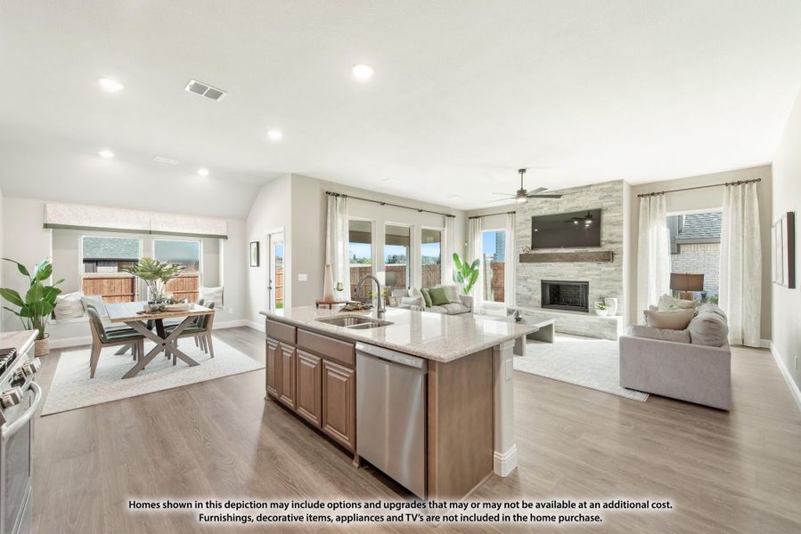 Open-concept layout with kitchen island, dining area, and living room with stone fireplace and hardwood floors Open-concept layout with kitchen island, dining area, and living room with stone fireplace and hardwood floors