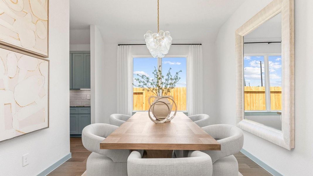Spacious dining area with vinyl wood flooring, large window and a tall ceiling. Spacious dining area with vinyl wood flooring, large window and a tall ceiling.