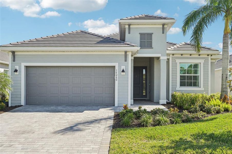 Front exterior of a new home in , Venice, FL, highlighting curb appeal (Image 1).