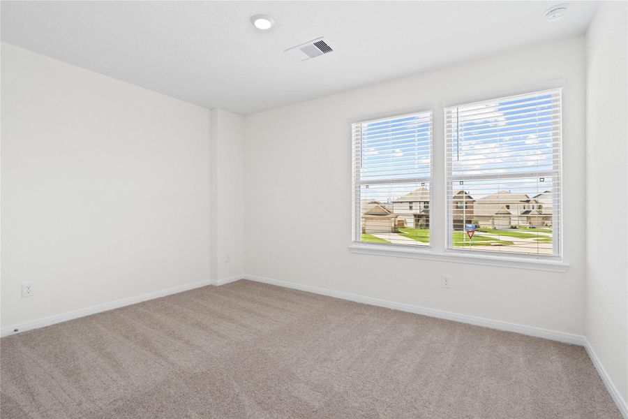 This secondary bedroom combines comfort and style, featuring plush carpeting, neutral paint, recessed lighting, large windows with blinds, and a spacious closet. This secondary bedroom combines comfort and style, featuring plush carpeting, neutral paint, recessed lighting, large windows with blinds, and a spacious closet.