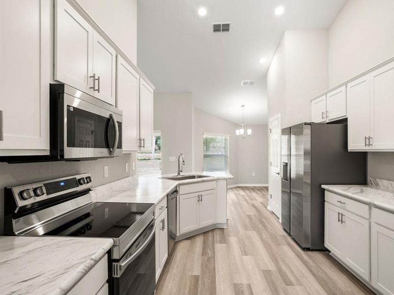 Your new kitchen is open to the cafe and includes 36-inch cabinets, a walk-in pantry, and Samsung SS appliances.