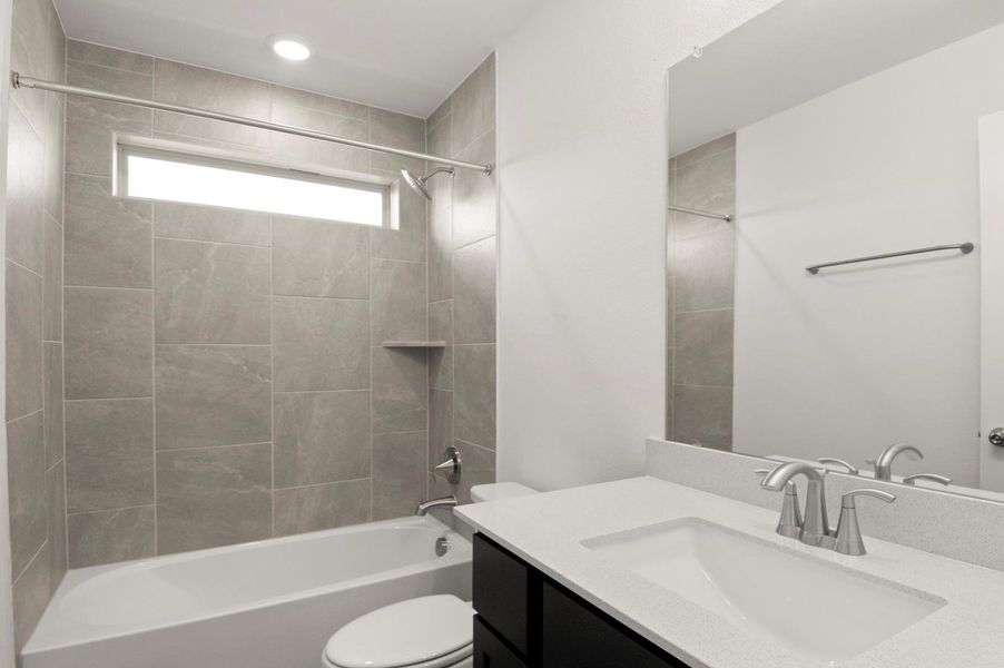 Full bathroom featuring vanity, bathtub / shower combination, and recessed lighting