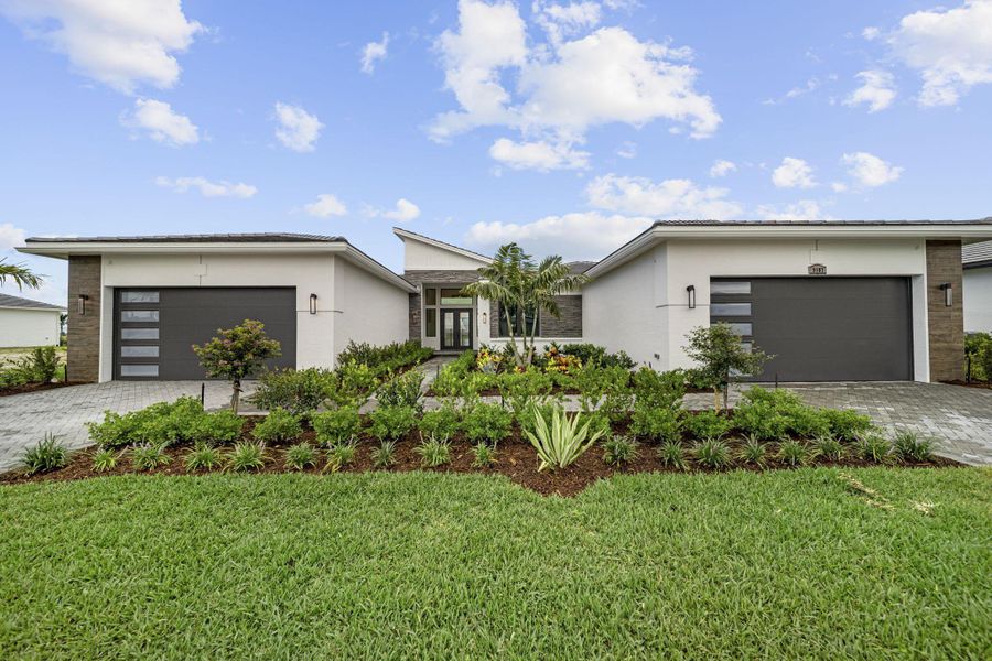 Front exterior of a new home in Astor Creek Golf & Country Club, Port St. Lucie, FL, highlighting curb appeal (Image 20).