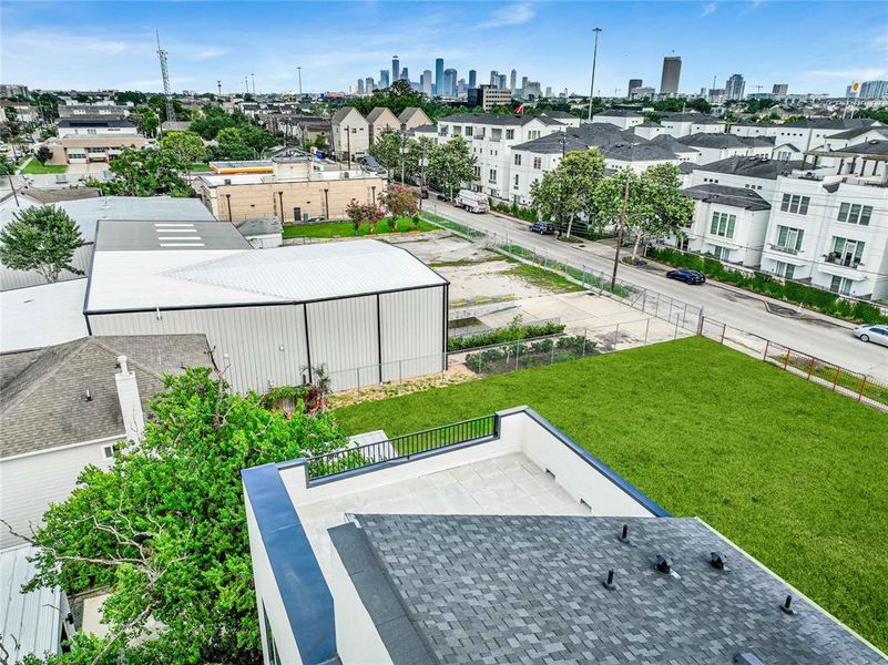 Captivating aerial view of a spacious rooftop terrace, perfect for outdoor relaxation and entertainment.