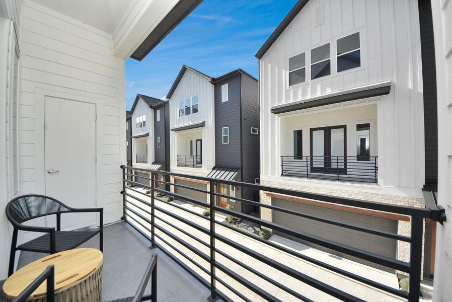 This cozy balcony offers a serene outdoor space with sleek railings, two chairs, and a small table—ideal for enjoying morning coffee or evening relaxation while taking in the neighborhood views. This cozy balcony offers a serene outdoor space with sleek railings, two chairs, and a small table—ideal for enjoying morning coffee or evening relaxation while taking in the neighborhood views.