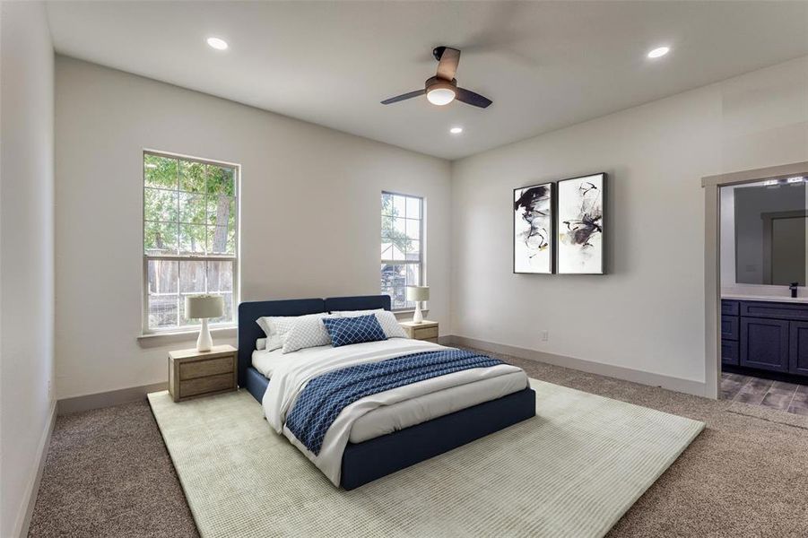 Carpeted bedroom featuring ensuite bath, ceiling fan, and sink