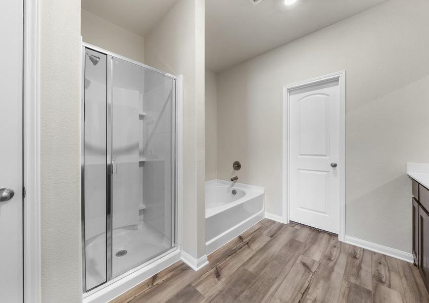 The master bathroom of the Cypress has a large glass, walk-in shower and gorgeous garden tub.