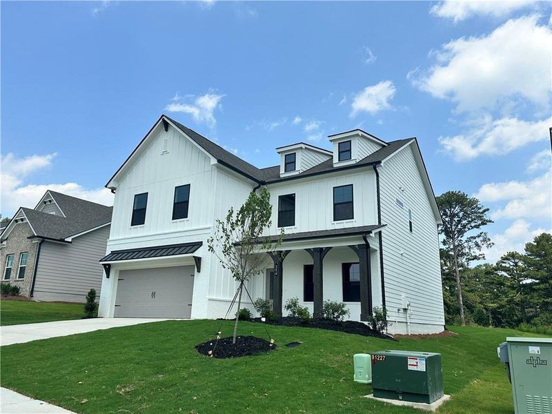 Front exterior of a new home in Summerlin, Winder, GA, highlighting curb appeal (Image 26). Front exterior of a new home in Summerlin, Winder, GA, highlighting curb appeal (Image 26).