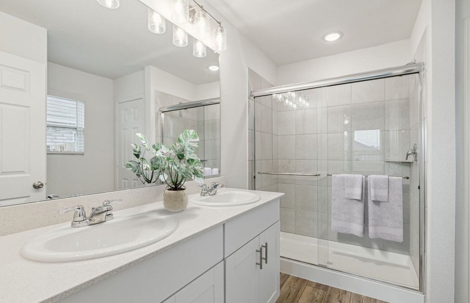 Owner's bath with double vanity and spacious showe