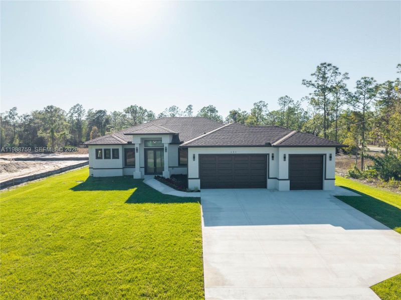 Front exterior of a new home in , Lehigh Acres, FL, highlighting curb appeal (Image 2). Front exterior of a new home in , Lehigh Acres, FL, highlighting curb appeal (Image 2).