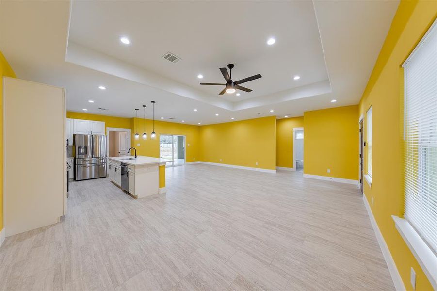 Living room featuring stylish wood-like floors, adding warmth and elegance to the space while enhancing durability.