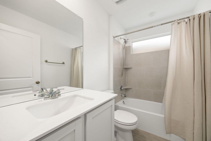 A well-lit guest bathroom provides both functionality and style.
