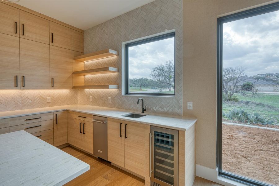 Bar has built-in wine fridge and ice maker