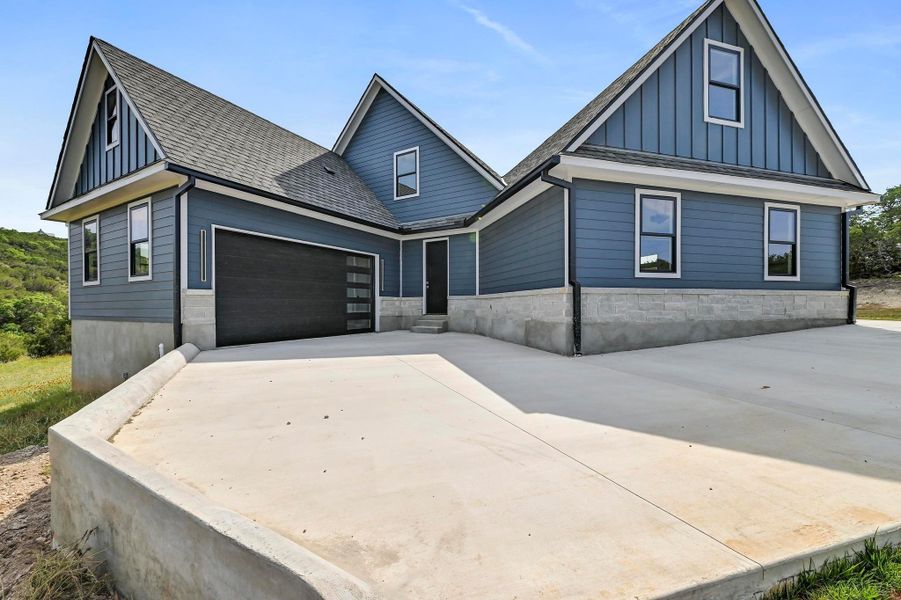 Breathtaking architectural design with a covered front porch, three front facing garage bays, and an additional 2 bay garage around the side. Breathtaking architectural design with a covered front porch, three front facing garage bays, and an additional 2 bay garage around the side.